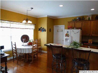Eating area in kitchen overlooks large backyard.