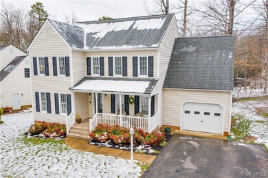 Vinyl siding with a great front porch and paved dr