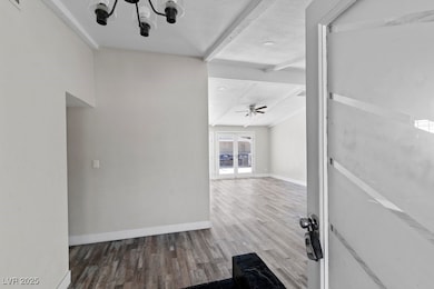 Hall with laminate flooring, beamed ceiling, frenc