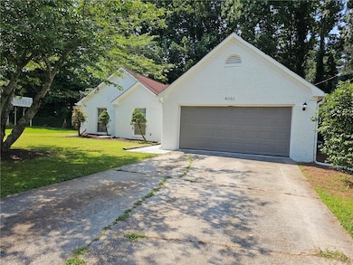 View of front of home featuring a front lawn and a garage