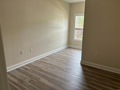 Unfurnished room featuring dark wood-style flooring