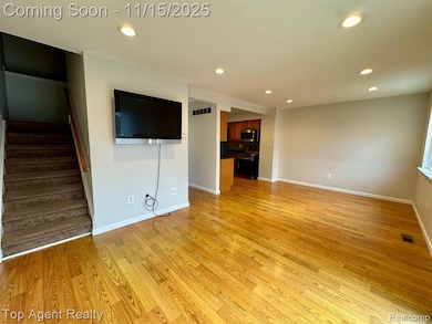 Unfurnished living room with recessed lighting, stairs, and light wood-type flooring