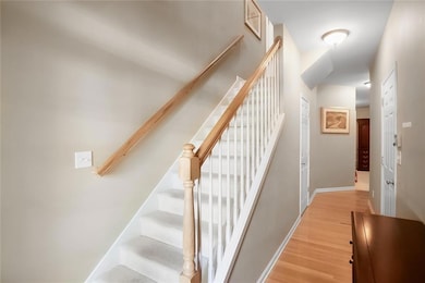 Stairway featuring baseboards and wood finished fl
