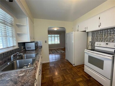 Kitchen featuring white appliances, stone look cou