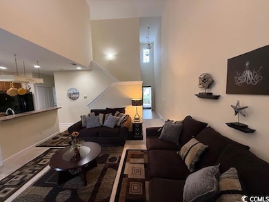 Living room featuring a high ceiling
