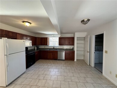 Kitchen featuring light tile flooring, sink, washe