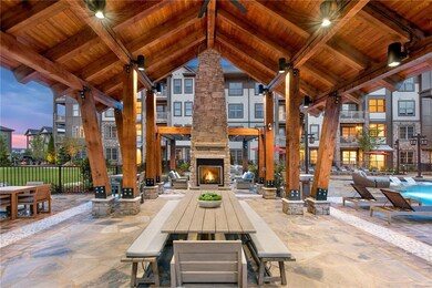 Patio terrace at dusk featuring an outdoor stone f