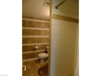 Full bath off the laundry room with shower. Cerami