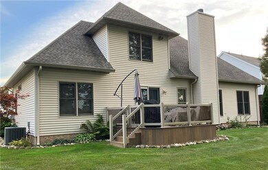 Rear view of house featuring a yard and central AC