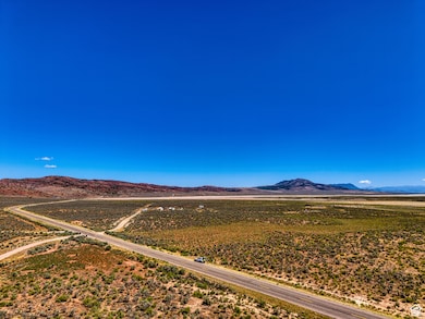 View of mountain backdrop with rural landscape