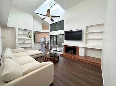 Living room featuring high vaulted ceiling, a cei