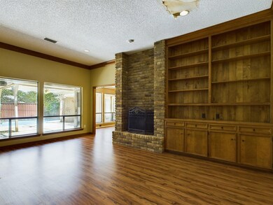 living room with brick wall, a textured ceiling, d
