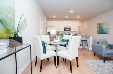 Dining space with recessed lighting, light wood-st