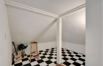 Additional living space featuring tile patterned 