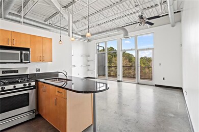 Kitchen with stainless steel gas stove, a sink, co