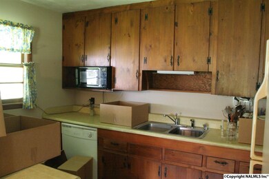 Kitchen has a bar area.