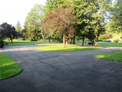 another view of driveway and front yard