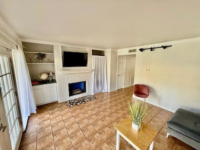 Living room with fire place, built in cabinets, cr