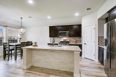 Kitchen with stainless steel appliances, a sink, 