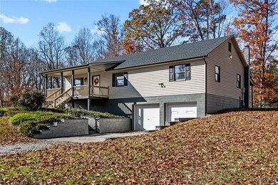 View of front facade with a porch and a garage