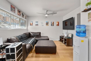 Living area featuring light wood-style flooring and a ceiling fan