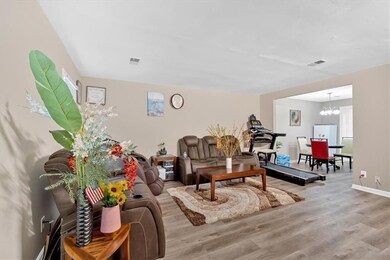 Living area with baseboards, wood finished floors,