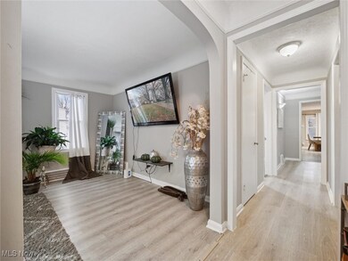Hallway featuring light wood-style flooring and arched walkways