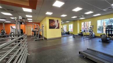 Gym featuring a drop ceiling, baseboards, and heal