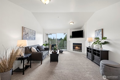 Living room with fireplace and vaulted ceilings