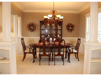 Formal front dining room with elegant columns and 