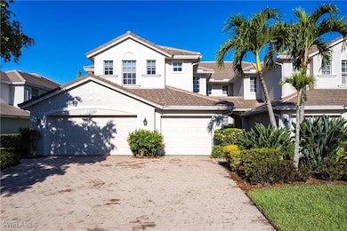 View of front of property with a garage, stucco si