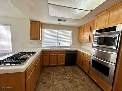 Kitchen featuring stainless steel appliances, tile