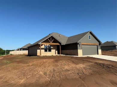 View of front of house with brick siding, a garage, and concrete driveway