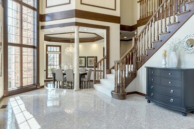 Gracious stairway leads upstairs and back stairs lead to the kitchen.