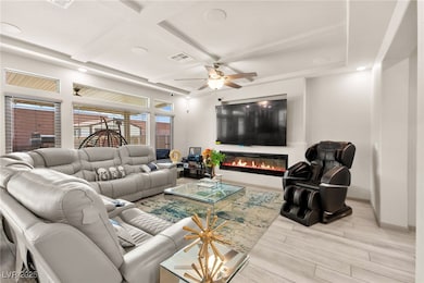 Living room with wood finished floors, a glass cov