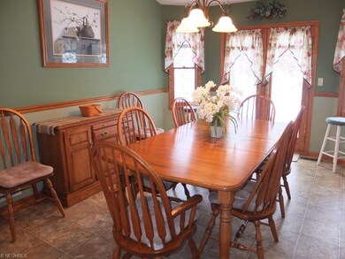 Formal dining room has vaulted ceiling and access 