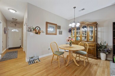 Dining space with a chandelier, light wood-type flooring, and baseboards