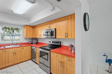 Kitchen with a tray ceiling, light tile patterned