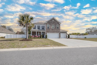 Traditional home with fence, driveway, brick sidin