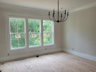 Large windows in primary suite.  Hardwoods, recessed lights and a chandelier.