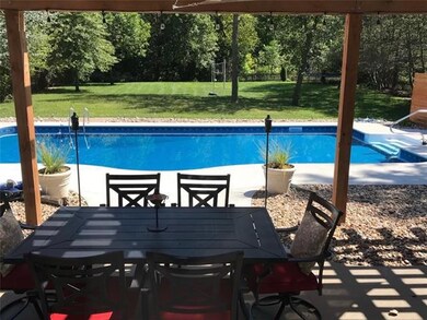 Summertime at the pool in the huge backyard with tons of trees and privacy! 
