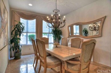 Formal dining with stunning chandelier, custom win