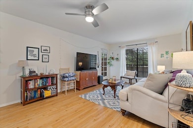 Living area with light wood-type flooring and ceiling fan