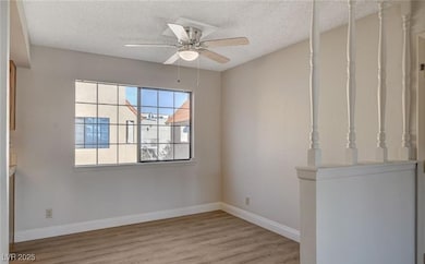 Spare room featuring wood finished floors, a textu