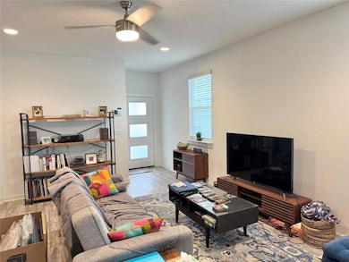 Living room featuring wood finished floors, a cei