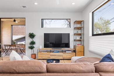 Living room with ceiling fan, wood finished floor