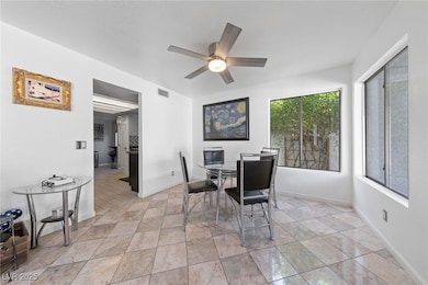 Dining room with ceiling fan, baseboards, and ligh