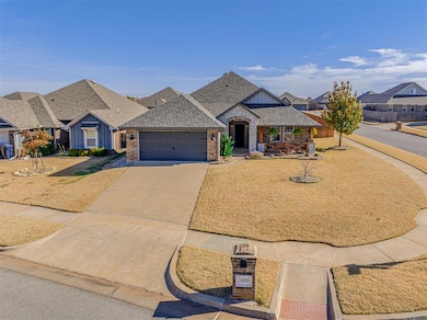 French country inspired facade featuring a shingled roof, driveway, an attached garage, stone siding, and board and batten siding