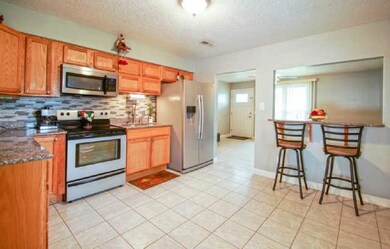 Great kitchen!  The countertops blend wonderfully with the wood cabinents, and the eat-in bar area makes perfect use of the space!