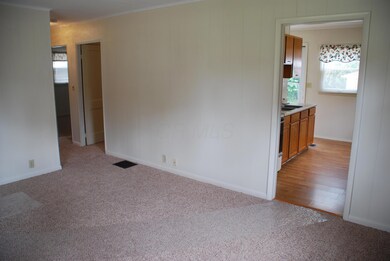 Living Room: new neutral carpet. Access to the kitchen, full bathroom and bedrooms.